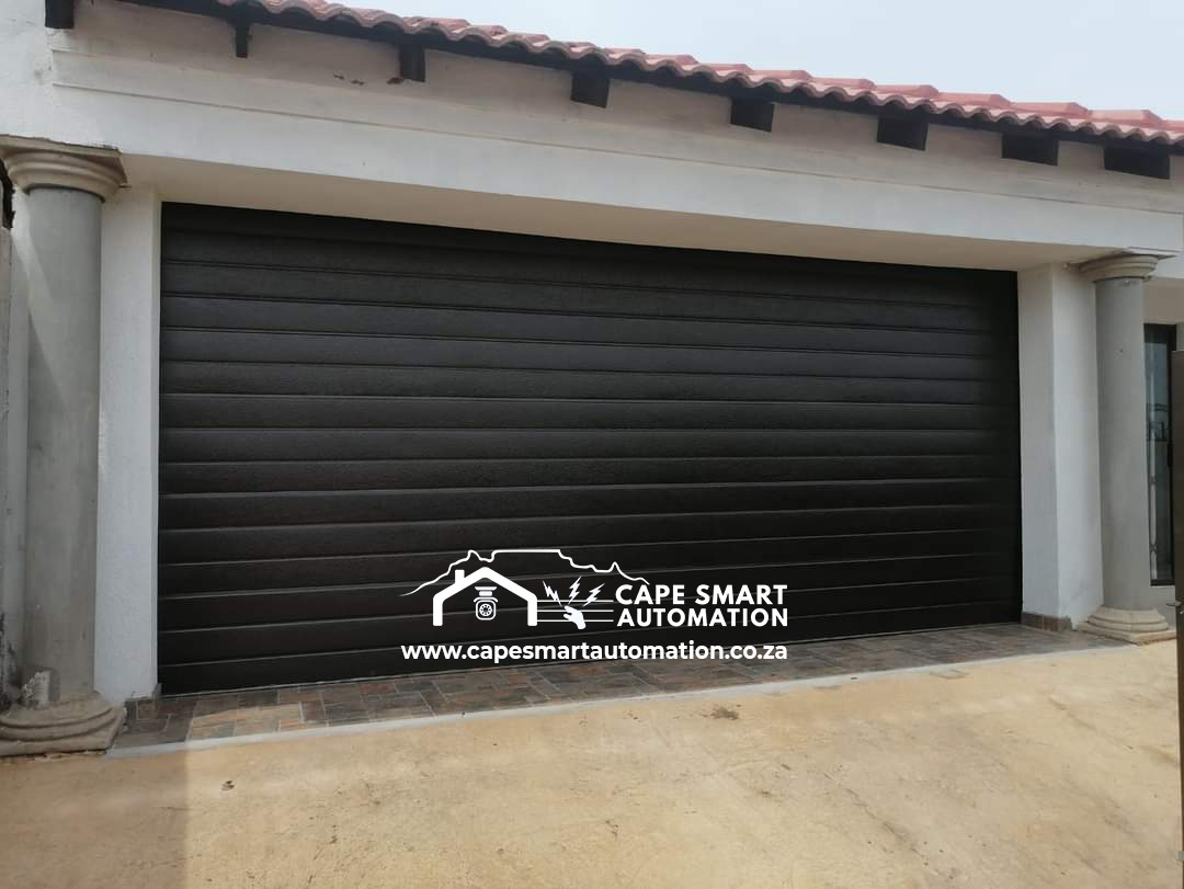Modern black automated garage door at a residential property