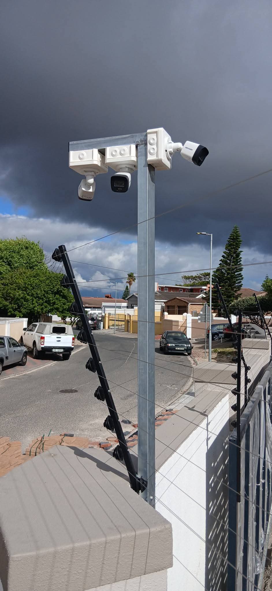 Combined CCTV cameras and electric fence installation on a residential boundary